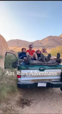 a group of people sitting on the back of a truck at مغامرات عين رم in Jurf ad Darāwīsh