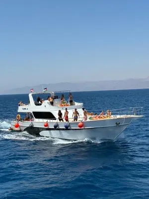 a group of people on a boat in the water at Camel Dive Club By The Sea Inn in Jurf ad Darāwīsh