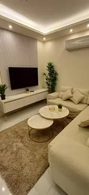 a living room with a couch and a flat screen tv at LV luxury apartment Deir Ghbar in Amman