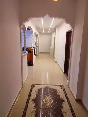 a hallway with an archway and a rug on the floor at bong chalet in Amman