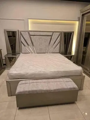 a bed in a room with a large bed sidx sidx sidx at bong chalet in Amman