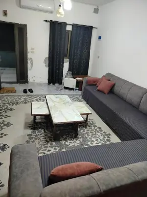 a living room with couches and a coffee table at شقق ابو يزن عجلون بالقرب من محمية عجلون in Ajloun