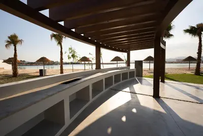 a building with a view of the beach and palm trees at Emerald Beach Apartment in Aqaba