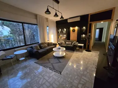 a living room with a couch and a table at Rainbow Retreat - 2BR in the heart of Old Amman in Amman