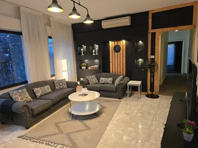 a living room with a couch and a table at Rainbow Retreat - 2BR in the heart of Old Amman in Amman