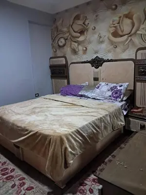 a bedroom with a large bed with a wall at البويضه هاوس in Al Buwayḑah