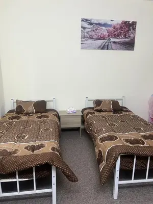 two beds sitting next to each other in a room at Altamem apartment in Um Qeis
