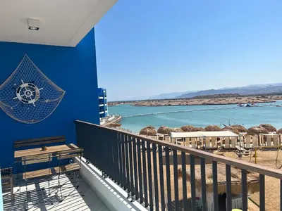 a balcony with a view of the beach and the ocean at Ayla Beach Apartment Azure 1522 Families only in Aqaba