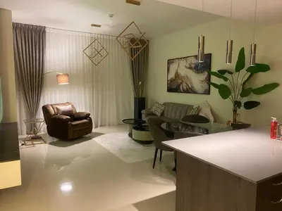 a living room with a couch and a chair at Boulevard luxury Studio in Amman