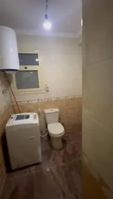 a bathroom with a toilet and a sink at الثغره هاوس in Abū al Lasan
