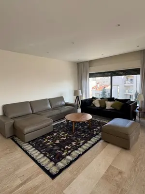 a living room with a couch and a table at The Olive- Bright, Spacious&Newly Renovated in Amman