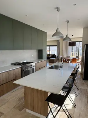 a kitchen with a large white island in a room at The Olive- Bright, Spacious&Newly Renovated in Amman