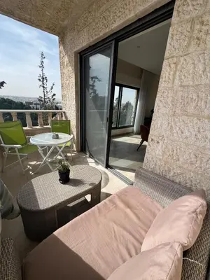 a living room with a couch and a table at The Olive- Bright, Spacious&Newly Renovated in Amman