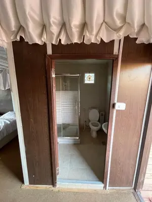 an open door to a bathroom with a toilet at My X wadirum in Wadi Rum