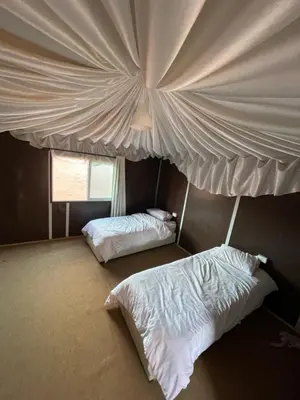 a bedroom with two beds and a ceiling at My X wadirum in Wadi Rum