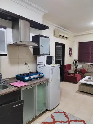 a kitchen with a sink and a refrigerator at عمان in Jurf ad Darāwīsh