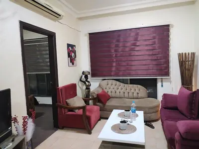 a living room with a couch and a table at عمان in Jurf ad Darāwīsh