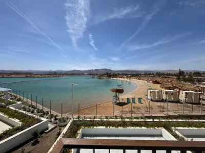a view of a beach with umbrellas and the ocean at Ayla Beach Apartment in Aqaba