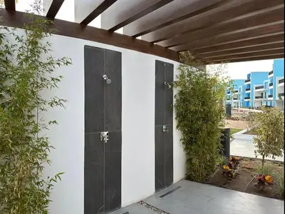 a house with black doors on the side of it at Ayla Beach Apartment in Aqaba