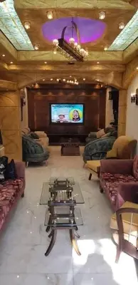 a large living room with couches and a flat screen tv at جرف العز هاوس in Jurf ad Darāwīsh