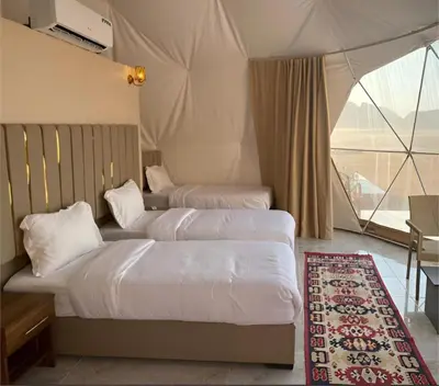 two beds in a room with a tent at Star Wars luxury camp in Wadi Rum