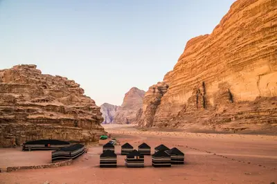 a group of chairs sitting in the middle of a canyon at Bedouin Luxury Camp in Wadi Rum