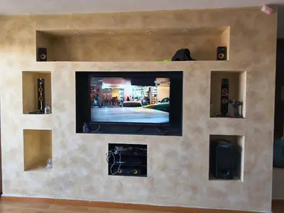 a wall with a flat screen tv in a living room at Shafa Badran Studio in Jurf ad Darāwīsh