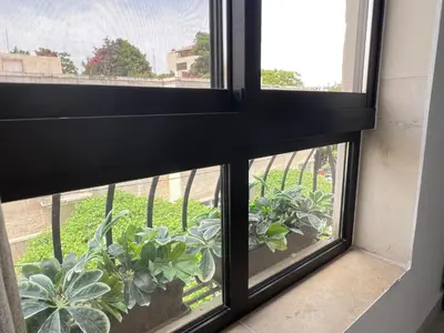 a window with a view of plants at Brand new, Modern, Breathtaking view, just for you in Amman