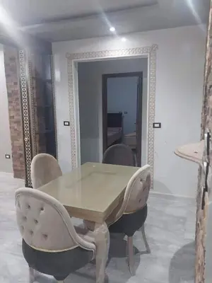 a dining room with a table and chairs and a mirror at ابيت السعاده in Ar Ramthā