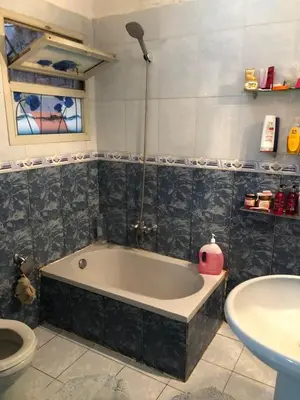 a bathroom with a bath tub and a toilet at ابيت السعاده in Ar Ramthā