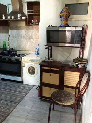 a kitchen with a stove and a microwave at ابيت السعاده in Ar Ramthā