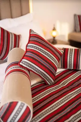 a bed with two pillows on top of it at Radisson Wadi Rum Luxury Camp in Wadi Rum
