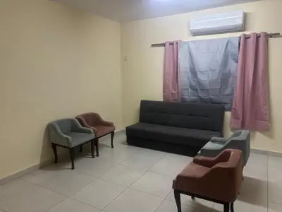 a waiting room with a couch and two chairs at Bubbles in Jurf ad Darāwīsh