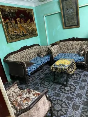 a living room with two couches and a table at مخيم الخال in Yarqā