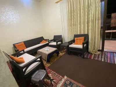 a living room with couches and chairs and a table at Mohmad House in Jurf ad Darāwīsh