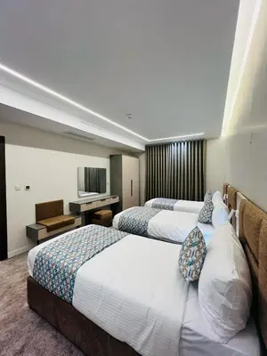 a hotel room with two beds and a television at فندق الأمراء بلازا in Ma‘ān