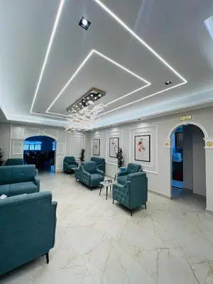 a lobby with couches and chairs and a piano at فندق الأمراء بلازا in Ma‘ān