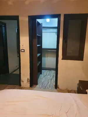 a bedroom with a door open to a closet at الجبل الاخضر هاوس in Al ‘Ālūk