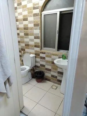a bathroom with a toilet and a sink at شقة الياسمين عمّان الأرضيّة للعائلات in Amman