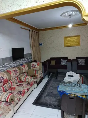 a living room with couches and a flat screen tv at شقة الياسمين عمّان الأرضيّة للعائلات in Amman