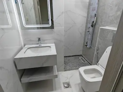 a white bathroom with a sink and a toilet at Furnished apartment - Irbid in Irbid