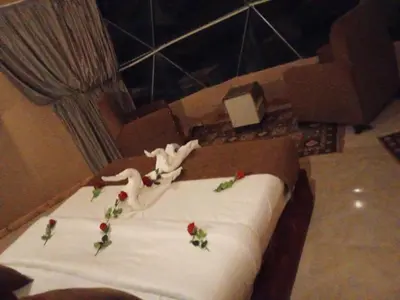 a bed with flowers on top of it at Wasan Camp Wadi Rum in Wadi Rum