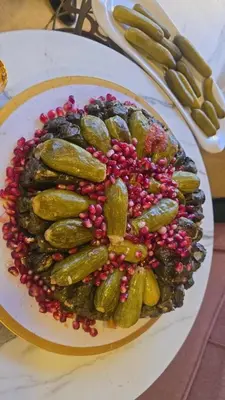 a plate of food with pickles on a table at ايدون هاوس in Aydūn