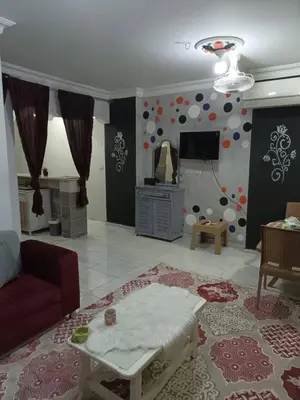 a living room with a couch and a tv at ايدون هاوس in Aydūn