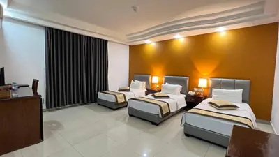a hotel room with two beds and a television at Tetra Tree Hotel 1 in Wadi Musa