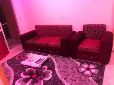 a living room with two chairs and a table at الاغوار هاوس in Khirbat ash Shaykh Muḩammad