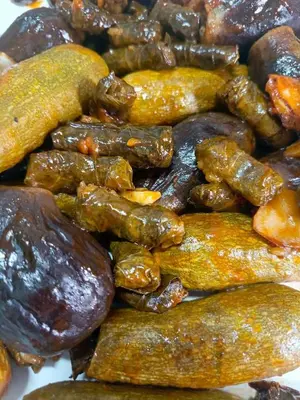 a pile of different types of food withneau at الاغوار هاوس in Khirbat ash Shaykh Muḩammad