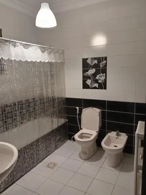 a bathroom with a toilet and a sink at Stay with Saja Room in Weibdeh in Jurf ad Darāwīsh