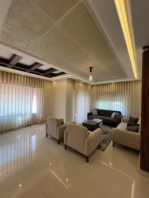 a large living room with couches and a table at Modern Luxe Getaway in Amman
