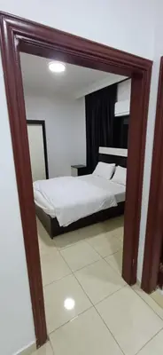 a mirror reflection of a bed in a bedroom at شقق الجبيهة العائلية in Amman